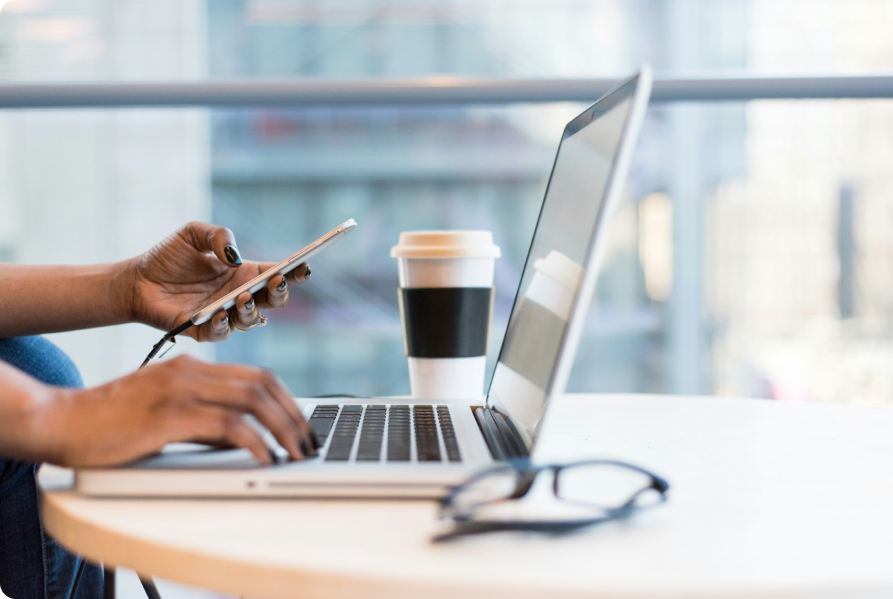 Person using a smartphone and laptop to participate in the VibePlate Affiliate Program