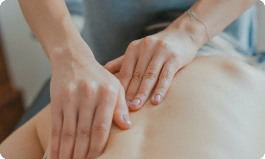 Therapist providing a back massage.