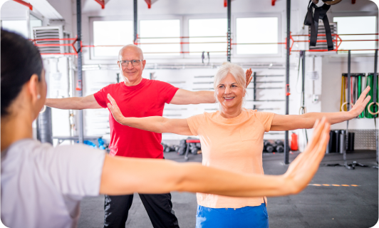 Seniors participating in a fitness class with arms outstretched