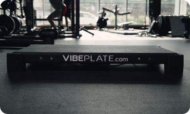 VibePlate's first model on a gym floor, symbolizing the start of the company in 2006