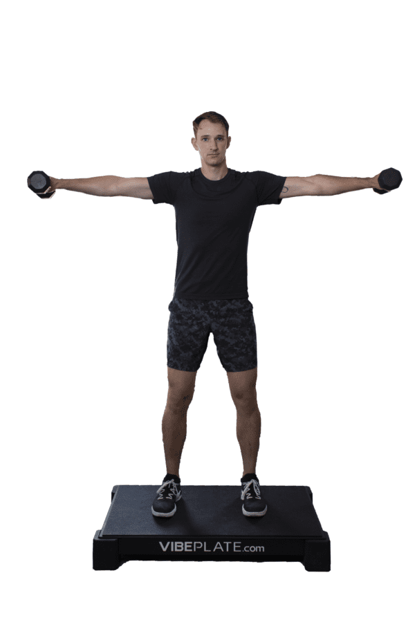 Man performing dumbbell exercises on VibePlate 2440