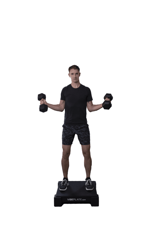 Man performing dumbbell exercises on a VibePlate 2424