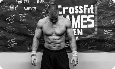 Scott Panchik, 9x CrossFit Games athlete, standing on VibePlate equipment